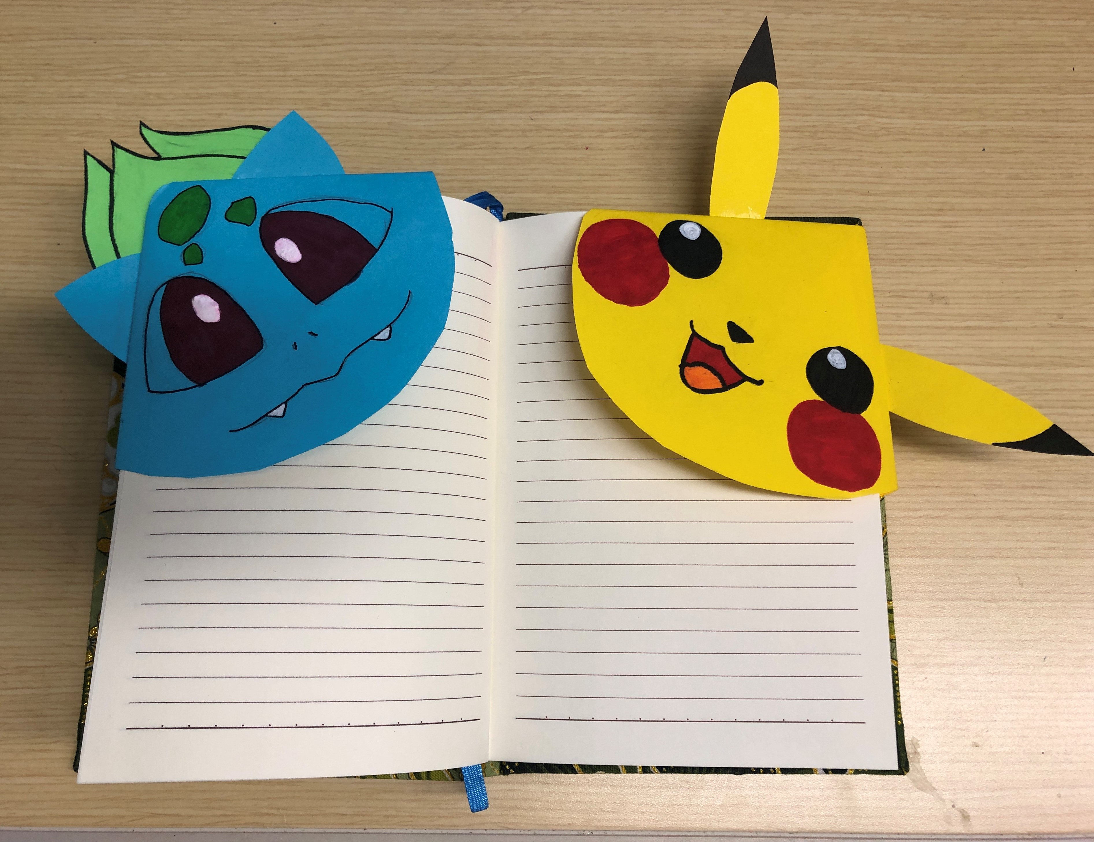 Origami of cartoon animals (pokemon) on a notebook