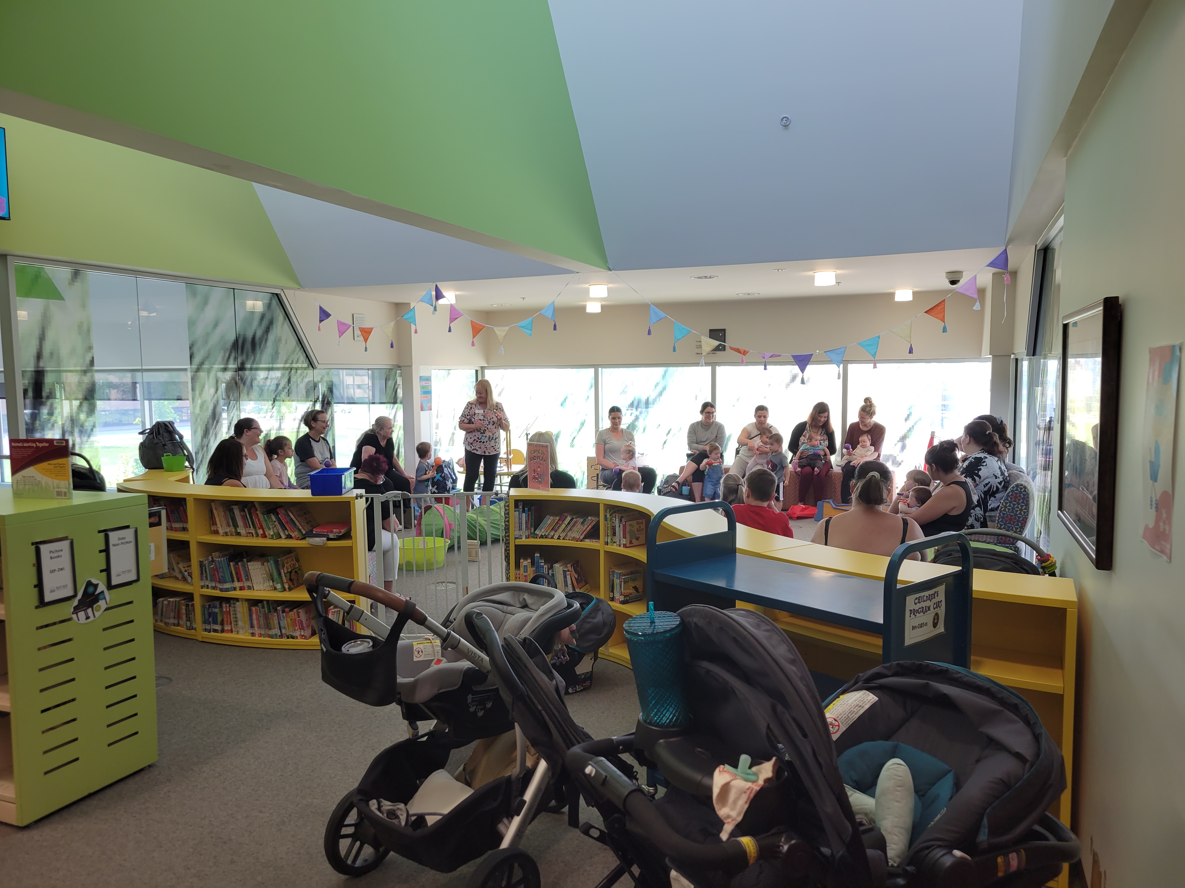 Babies and toddlers, along with caregivers, making music with our programmer.