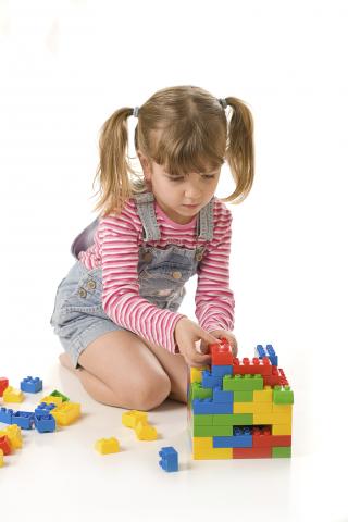 girl playing with coloured blocks