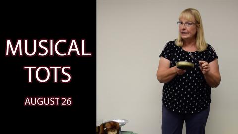 A woman stands holding a small pot and a spoon next to the text "Musical Tots August 26"