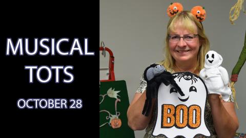 A woman holds a ghost puppet and a ghost sign that says "boo" next to the text "Musical Tots October 28"