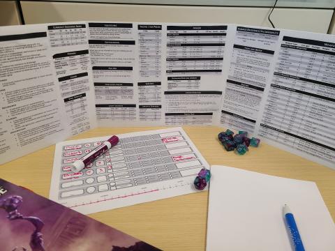 dm screen with dice and notes