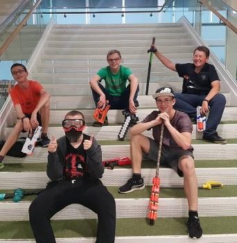 Teens with nerf guns sitting on the stairs