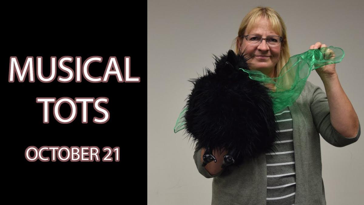 A woman holds a black bird puppet and a translucent green scarf next to the text "Musical Tots October 21"