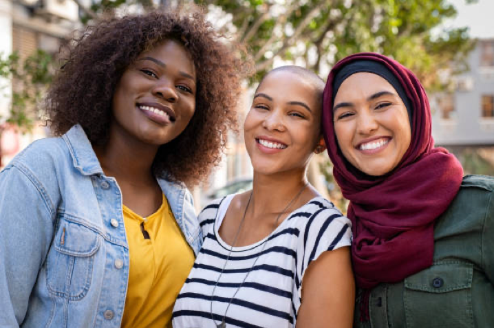 Three women of different cultures standing united 