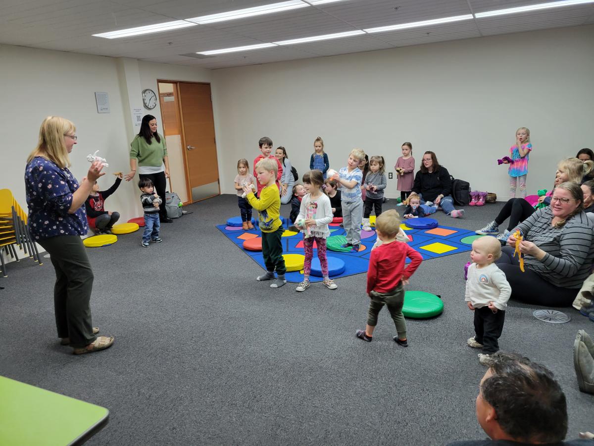 children singing and dancing with library programmer